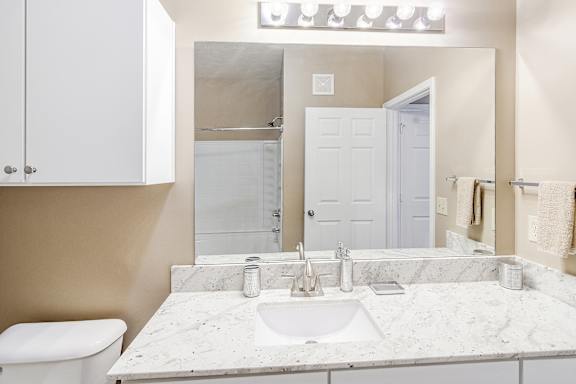 bathroom with a granite countertop at The Vineyard of Olive Branch Apartment Homes, Olive Branch