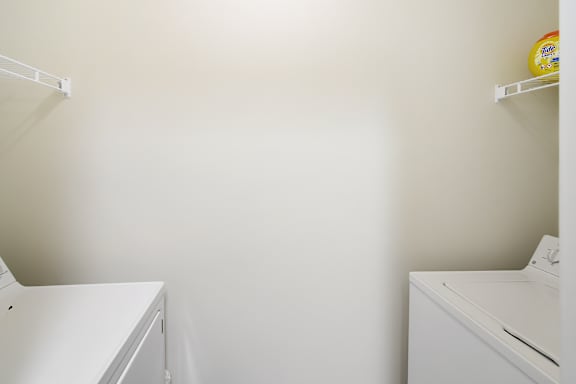 A white laundry room with a washer and dryer at Landing at Willow Bayou Apartment Homes in Bossier City, LA