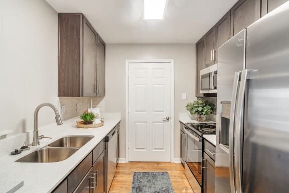 an empty kitchen with stainless steel appliances and a sink at Reserve of Jackson Apartment Homes, Jackson, MS