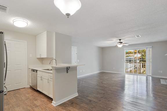 Hardwood floors in kitchen and living room  at The Woodlands Apartment Homes, Mississippi 39301