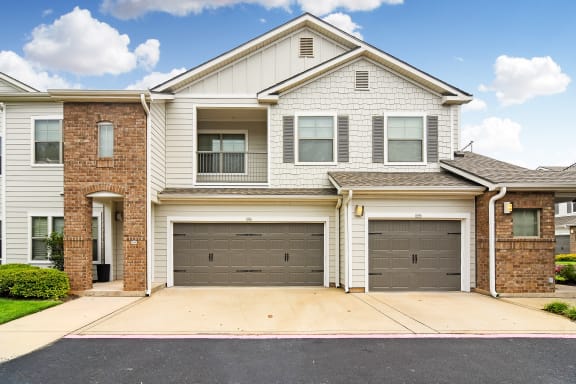 a white house with two garage doors  at Kingston Crossing Apartment Homes, Bossier City, Louisiana, 71111