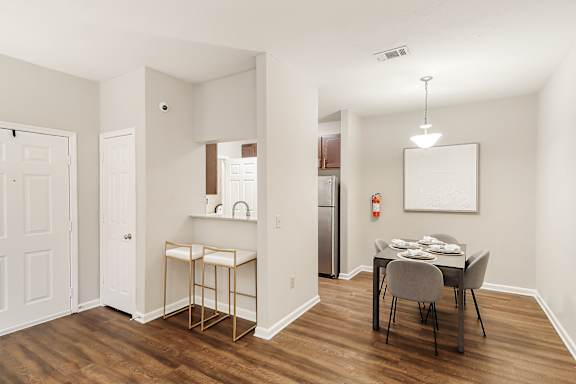 Impressive Dining Area Dining area with a table and chairs and hardwood floors at Highpointe Apartment Homes, Brandon, MS, Mississippi  , 39042