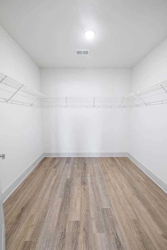 Empty room with wooden floor and white walls.