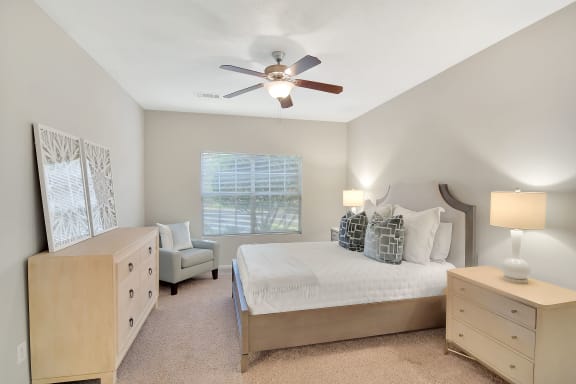 a bedroom with a bed and a ceiling fan at Ashford Place Apartment Homes, Flowood, MS