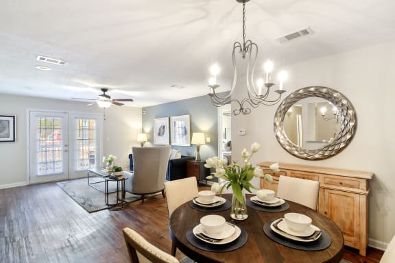 a rendering of a living room with a kitchen in the background at Bridgewater Apartment Homes, Mississippi 39047