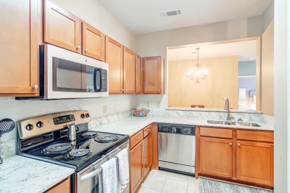 a kitchen with a stove and a wall with geometric patterns at The Vineyard of Olive Branch Apartment Homes in Olive MS 38654