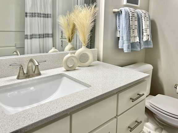 A bathroom with quartz countertops at Reserve at Park Place Apartments, Mississippi 39402