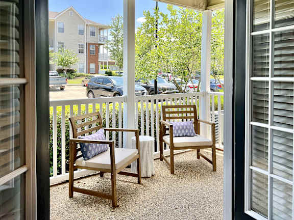 Two chairs and a bench are on a patio at Park Place Apartment Homes,  Hattiesburg,,