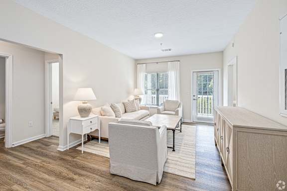 a living room with a couch and a table at The Met Apartment Homes, Mississippi