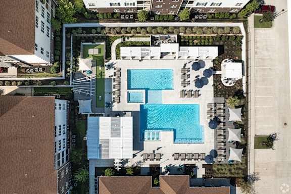 arial view of a swimming pool on the roof of a building at The Met Apartment Homes, Hattiesburg, Mississippi