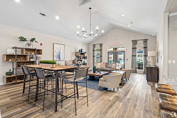spacious living room with dining table and chairs at The Met Apartment Homes, Mississippi 39402