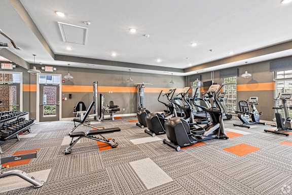 a gym with cardio equipment and weights at the apartments at The Met Apartment Homes, Mississippi