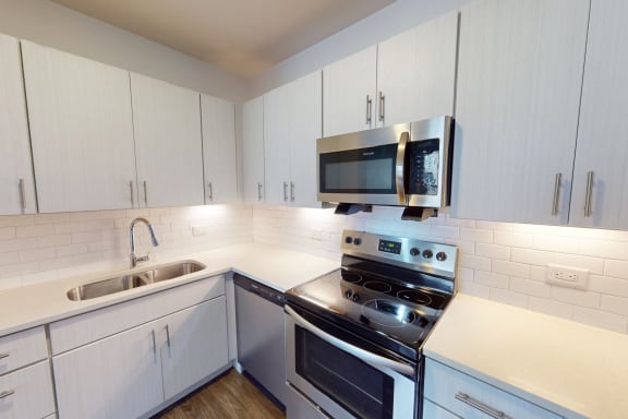 Over the range microwave with stainless steel appliances at The Whit Apartments in Indianapolis, IN 46204