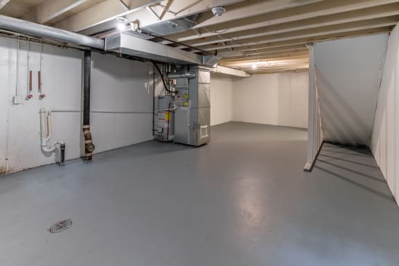 the inside of a garage with a white wall and a door