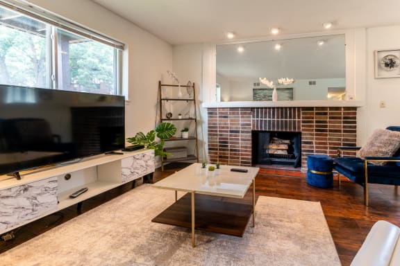 a living room with a fireplace and a television