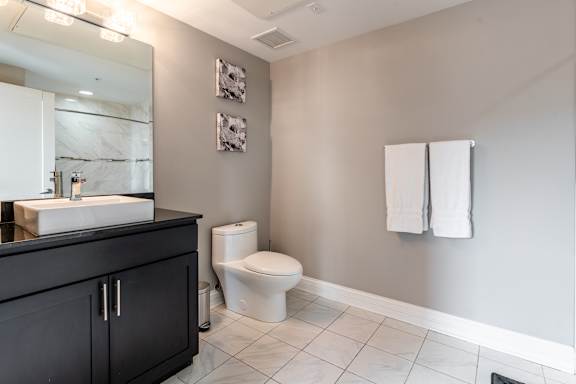Bathroom with a toilet and towel rack at Somerset Place Apartments, Chicago, IL, 60640