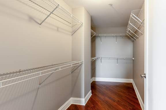 Walk in closet with white shelves at Somerset Place Apartments, Illinois
