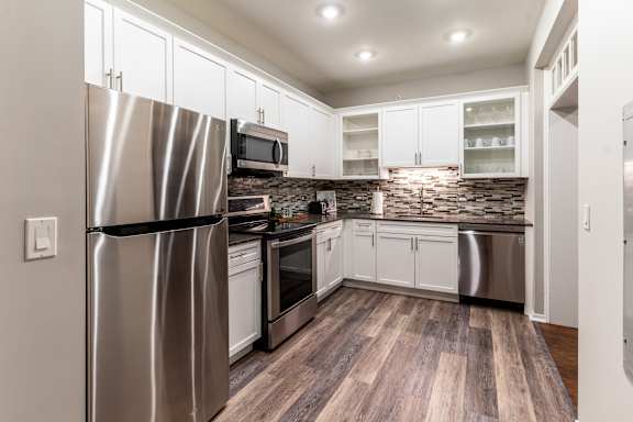 a kitchen with stainless steel appliances and white cabinets at Park Heights by the Lake Apartments, Chicago, 60649