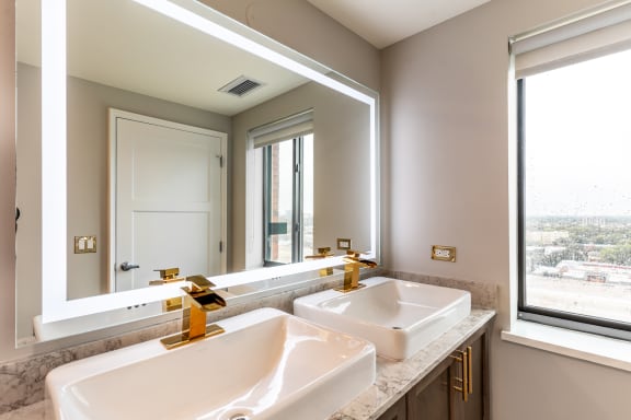 a bathroom with two sinks and a large mirror