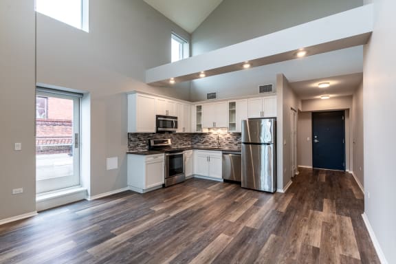 an open kitchen with stainless steel appliances and a large window