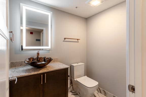 a small bathroom with a mirror and a toilet