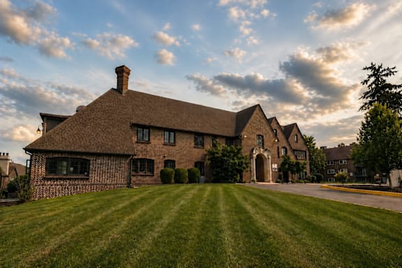 A large house with a thatched roof and a chimney.