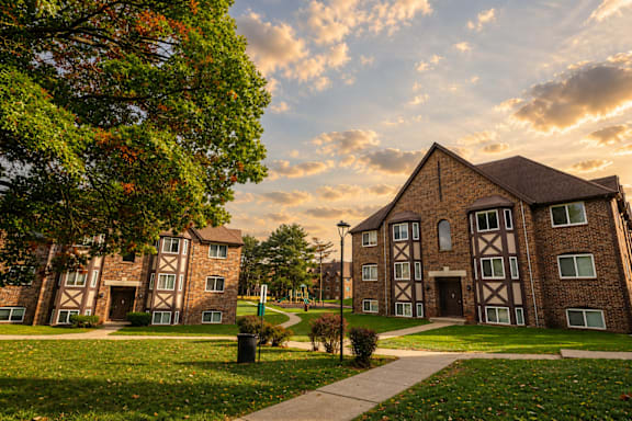 A large building with a green lawn in front.