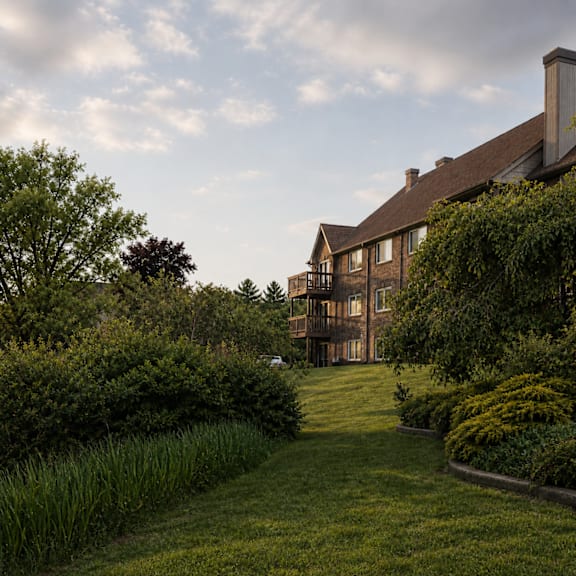 A large house with a long lawn in front of it.