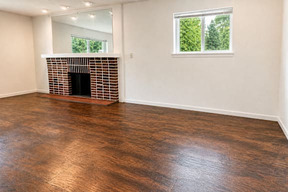 A room with a fireplace and a window.