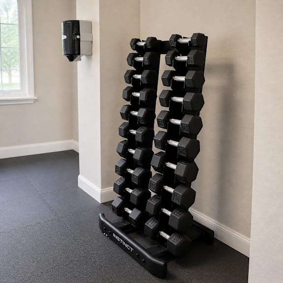 A set of black dumbbells are stacked on a black stand in a room with a window.