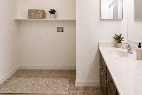 A bathroom with a white sink and a mirror.