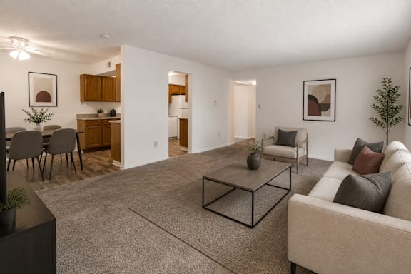 A living room with a couch, chairs, and a coffee table.