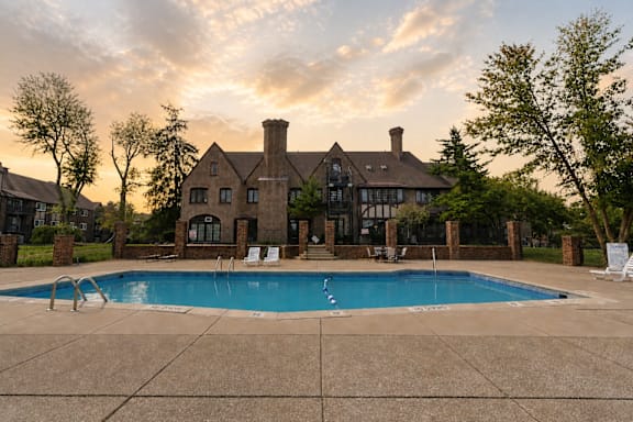 A large house with a pool in front.