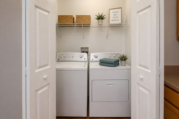 A small laundry room with a washer and dryer.