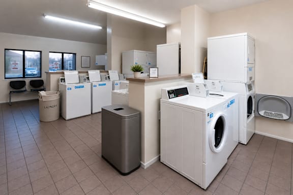 A laundry room with washers and dryers.