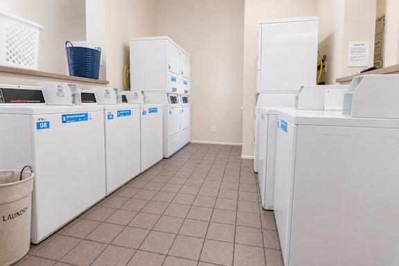 A row of washing machines in a laundromat.