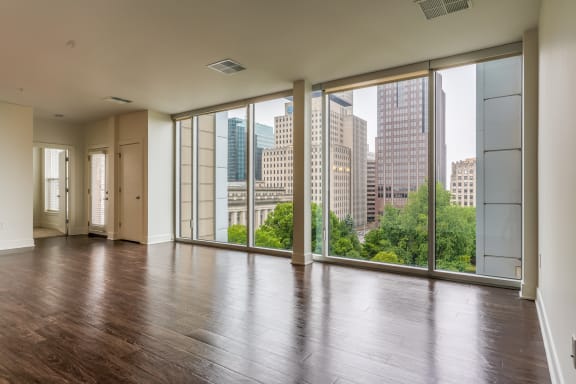 living room with floor to ceiling windows and a view of the city at The Whit Apartments in Indianapolis, IN 46204