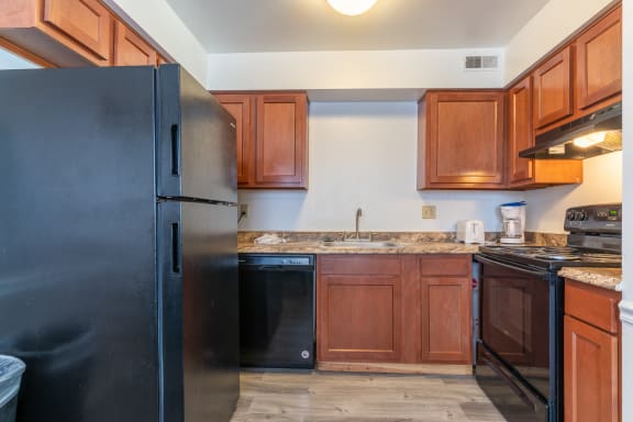 Wooden cabinets and appliances in the kitchen at Pickwick Farms Apartments, Indianapolis, Indiana