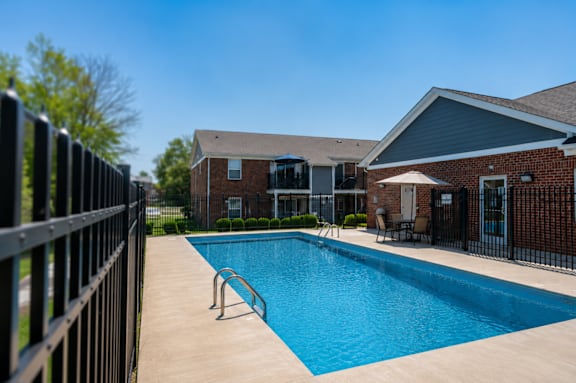 A swimming pool surrounded by a black fence.