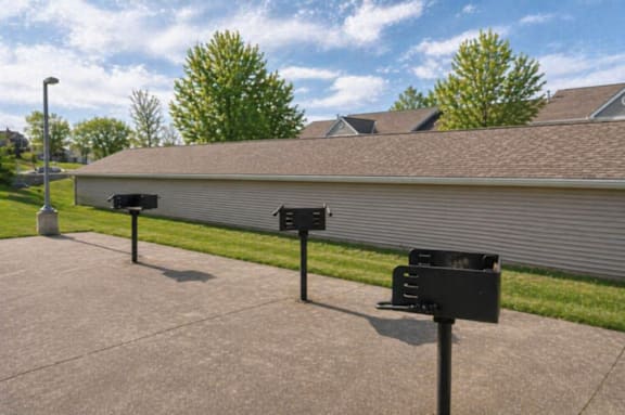 A black mailbox is on the left side of a street.