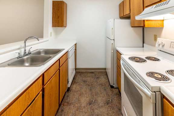 a kitchen with a stove sink and refrigerator at Creekside Square Apartments, Indianapolis, IN