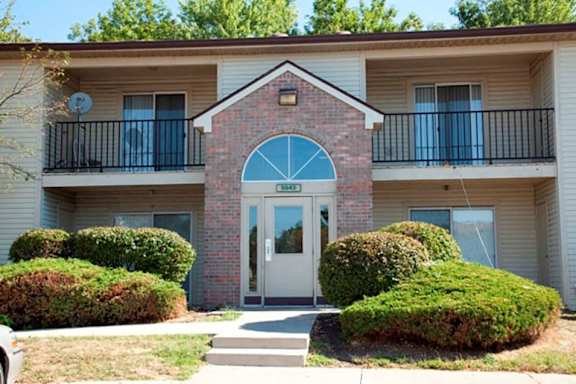 the front entrance of a building with a white door at Creekside Square Apartments, Indiana