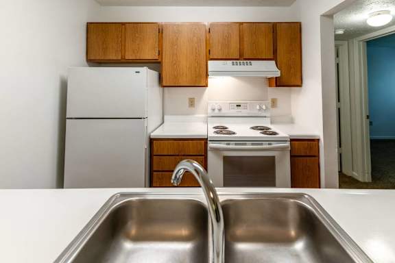 a kitchen with a sink and a stove and a refrigerator at Creekside Square Apartments, Indianapolis, 46254