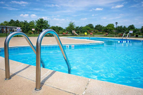 A blue pool with a ladder on the side.