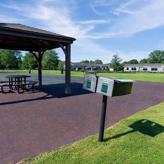 A gazebo is in the middle of a brick patio.
