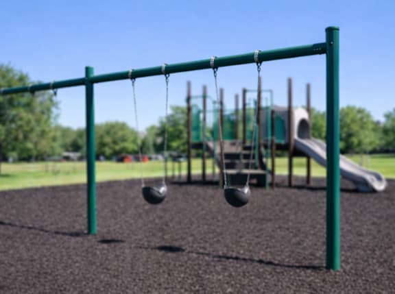 A playground with a swing set and a slide.
