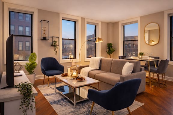 A living room with a blue chair and a grey couch.
