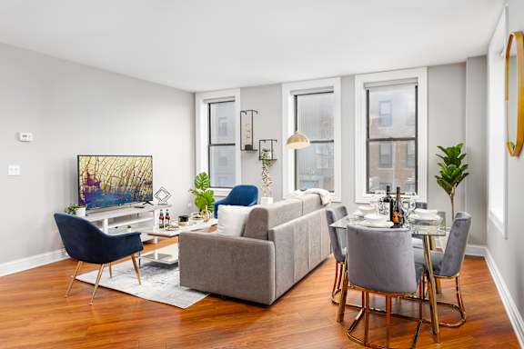 Modern Living Room with oversized windows at Somerset Place Apartments, Chicago