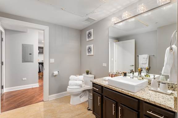 Bathroom with a sink and a toilet and a mirror at Somerset Place Apartments, Chicago