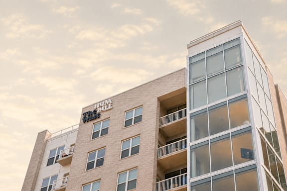 A tall building with a balcony on the second floor.